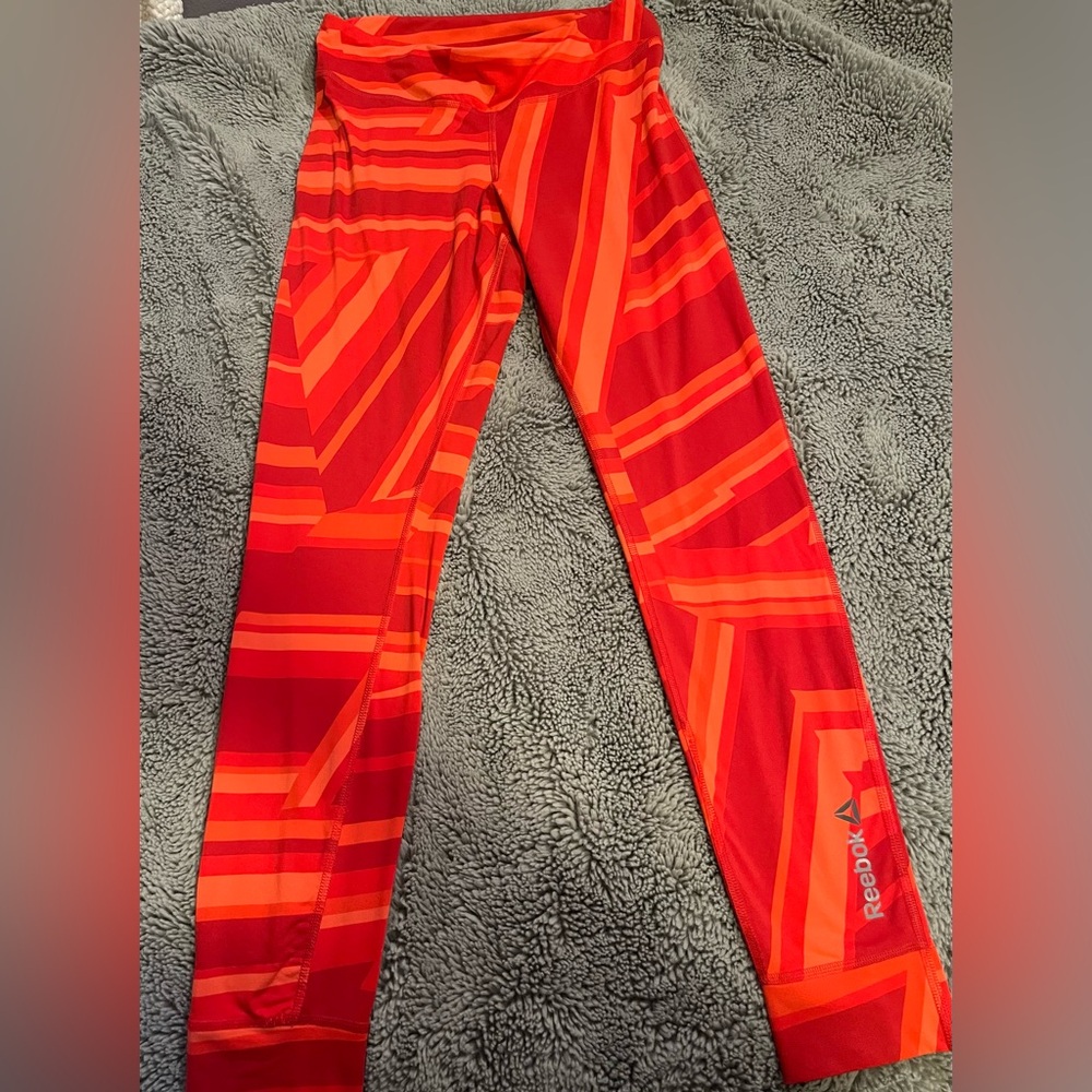 Woman’s size small red and orange Reebok running leggings. Size small.